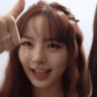 A Close Up Of A Woman Giving A Thumbs Up And Smiling . GIF