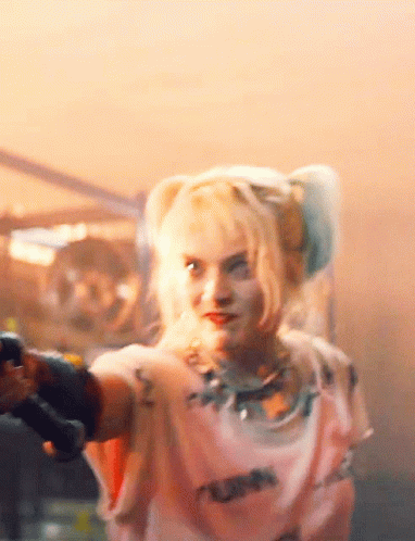 A Close Up Of A Woman Holding A Gun GIF