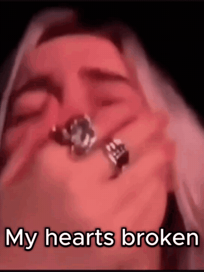 A Close Up Of A Woman Holding A Ring In Her Hand With The Words `` My Hearts Broken '' . GIF