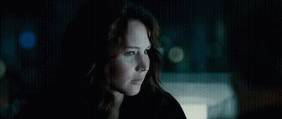 A Close Up Of A Woman In A Dark Room GIF