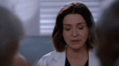 A Close Up Of A Woman In A Lab Coat GIF