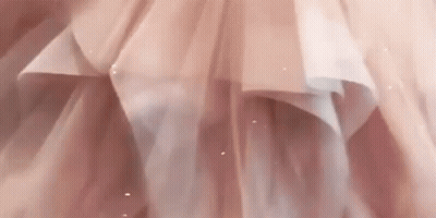 A Close Up Of A Woman In A Pink Dress GIF