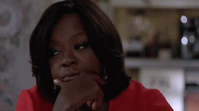A Close Up Of A Woman In A Red Shirt With Her Hand On Her Chin . GIF