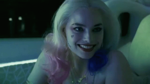 A Close Up Of A Woman In A Suicide Squad Costume Smiling . GIF