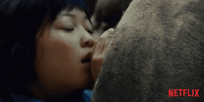 A Close Up Of A Woman Kissing A Rock With Netflix Written In Red On The Bottom GIF