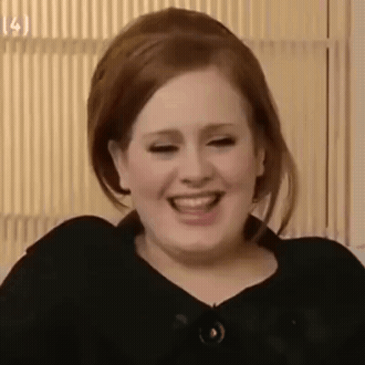 A Close Up Of A Woman Laughing While Wearing A Black Jacket . GIF