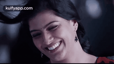 A Close Up Of A Woman Laughing With Her Eyes Closed . GIF