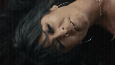 A Close Up Of A Woman Laying Face Down GIF