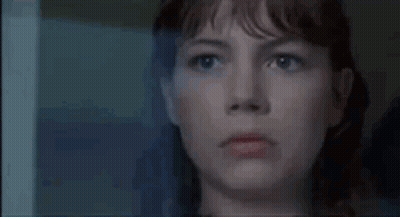 A Close Up Of A Woman Looking Out Of A Window . GIF