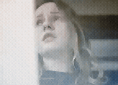 A Close Up Of A Woman Looking Up At Something . GIF