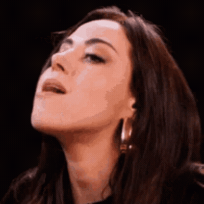A Close Up Of A Woman Looking Up With Her Mouth Open . GIF