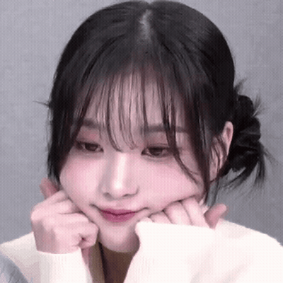 A Close Up Of A Woman Making A Face With Her Hands On Her Face . GIF