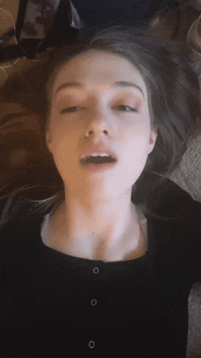 A Close Up Of A Woman Making A Face With Her Mouth Open GIF