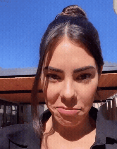 A Close Up Of A Woman Making A Face With Her Mouth Open GIF