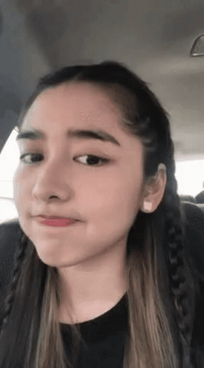 A Close Up Of A Woman Making A Funny Face GIF