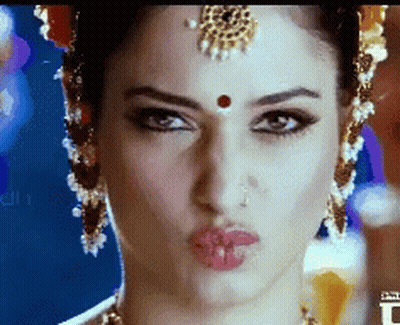 A Close Up Of A Woman Making A Funny Face GIF