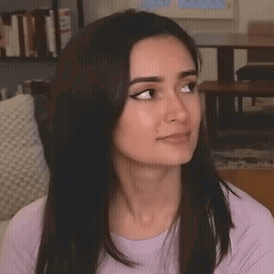 A Close Up Of A Woman Making A Funny Face While Sitting On A Couch In A Living Room . GIF