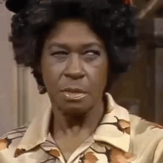 A Close Up Of A Woman Making A Funny Face While Wearing A Floral Shirt . GIF