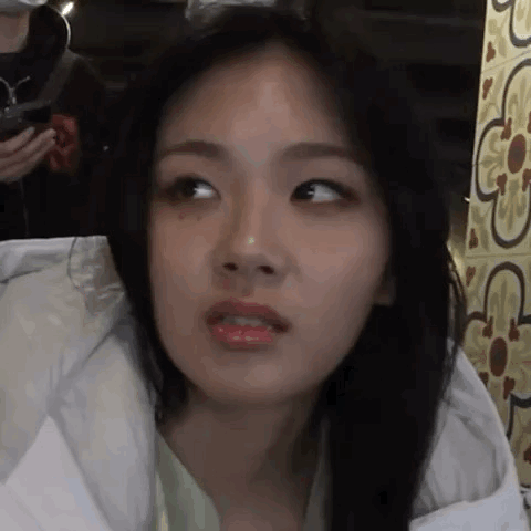 A Close Up Of A Woman Making A Funny Face While Wearing A Jacket . GIF