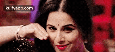 A Close Up Of A Woman Making A Funny Face With Her Hand On Her Face . GIF