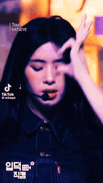A Close Up Of A Woman Making A Funny Face With Her Hands . GIF