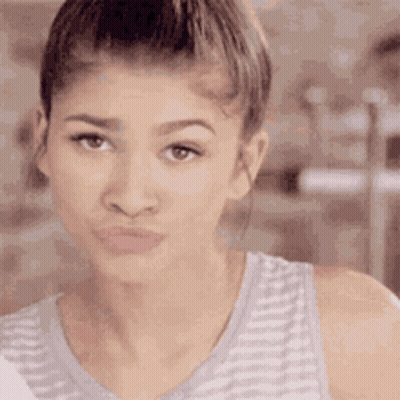A Close Up Of A Woman Making A Funny Face With Her Mouth Open . GIF