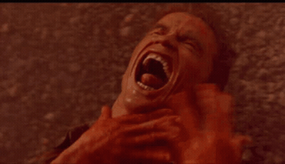 A Close Up Of A Woman Making A Funny Face With Her Mouth Open And Big Red Eyes . GIF