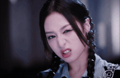 A Close Up Of A Woman Making A Funny Face With Her Mouth Open GIF