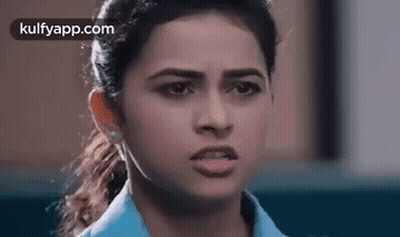A Close Up Of A Woman Making A Funny Face With Her Mouth Open . GIF
