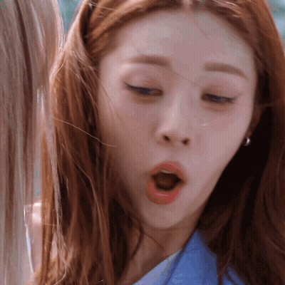 A Close Up Of A Woman Making A Funny Face With Her Mouth Open GIF