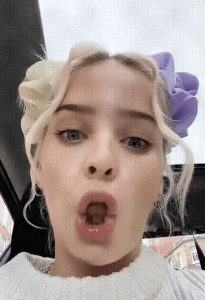 A Close Up Of A Woman Making A Funny Face GIF