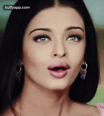 A Close Up Of A Woman Making A Surprised Face With Her Mouth Open . GIF