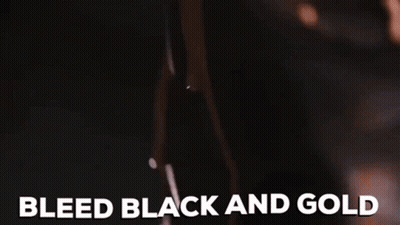 A Close Up Of A Woman 'S Breast With The Words Bleed Black And Gold Written On It . GIF