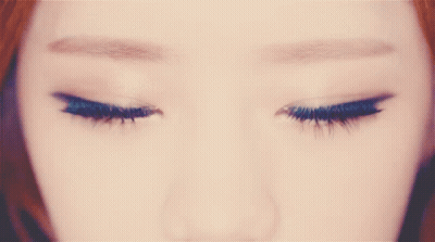 A Close Up Of A Woman 'S Brown Eyes With A Circle In The Middle GIF