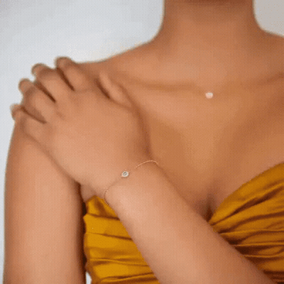 A Close Up Of A Woman 'S Ear With A Pair Of Gold Hoop Earrings GIF