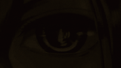 A Close Up Of A Woman 'S Eye With A Candle Reflection In It GIF