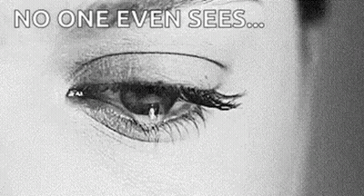 A Close Up Of A Woman 'S Eye With A Tear Coming Out Of It And The Words `` No One Even Sees '' . GIF