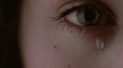 A Close Up Of A Woman 'S Eye With A Tear On It GIF