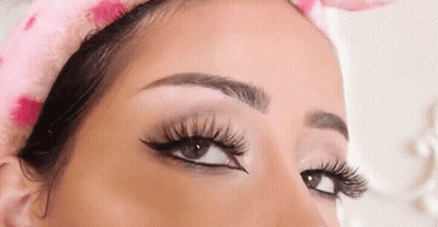 A Close Up Of A Woman 'S Eye With Long Eyelashes And Eyeliner . GIF