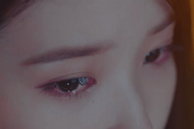 A Close Up Of A Woman 'S Eyes With A Purple Eyeshadow GIF