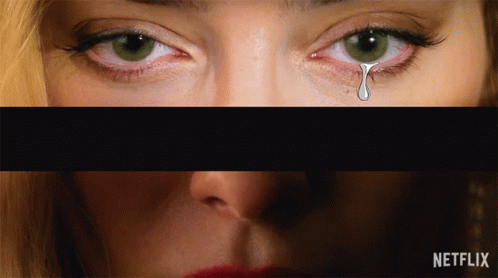 A Close Up Of A Woman 'S Eyes With A Tear Coming Out Of It GIF