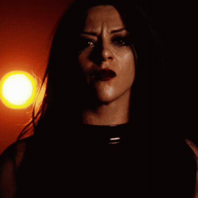 A Close Up Of A Woman 'S Face Against A Red Background GIF