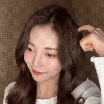 A Close Up Of A Woman 'S Face And Hair With A Person 'S Hand On It . GIF