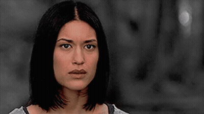 A Close Up Of A Woman 'S Face In A Black And White Photo . GIF
