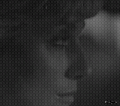 A Close Up Of A Woman 'S Face In A Black And White Photo GIF