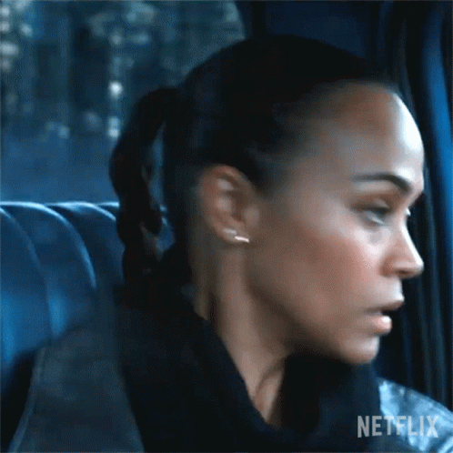A Close Up Of A Woman 'S Face In A Car With A Ponytail . GIF