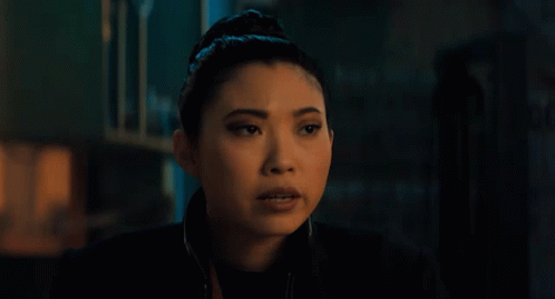 A Close Up Of A Woman 'S Face In A Dark Room GIF