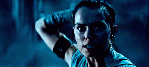 A Close Up Of A Woman 'S Face In A Dark Room GIF