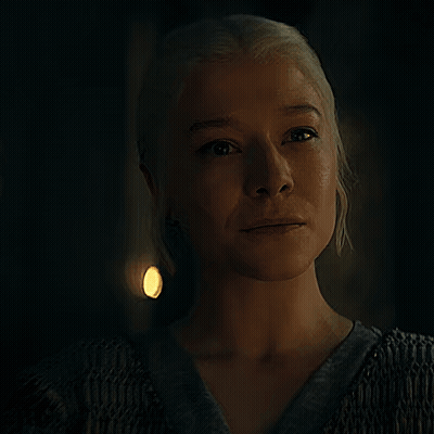 A Close Up Of A Woman 'S Face In A Dark Room GIF