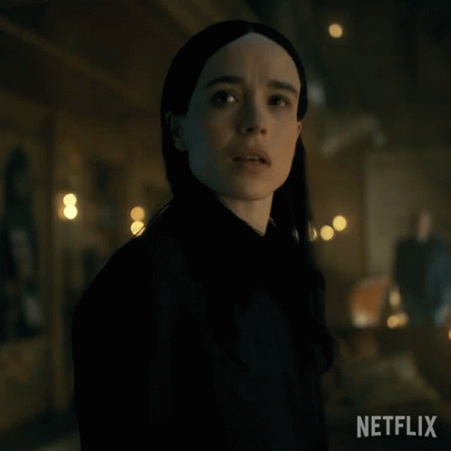 A Close Up Of A Woman 'S Face In A Dark Room With A Netflix Logo In The Corner GIF